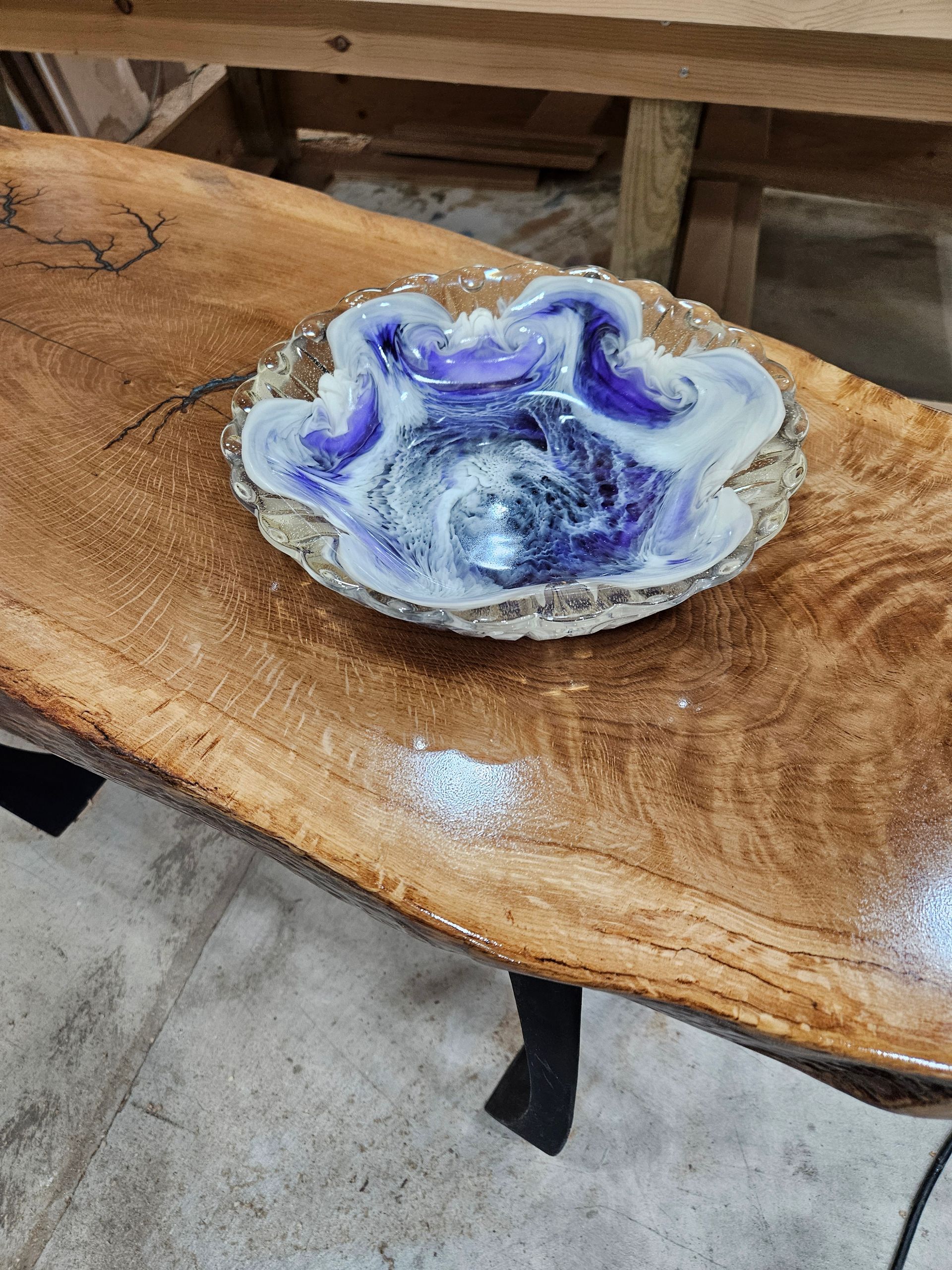 Purple and white glass dish on a polished wooden table
