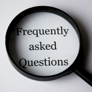 Magnifying glass over the words “Frequently asked Questions” on a white background