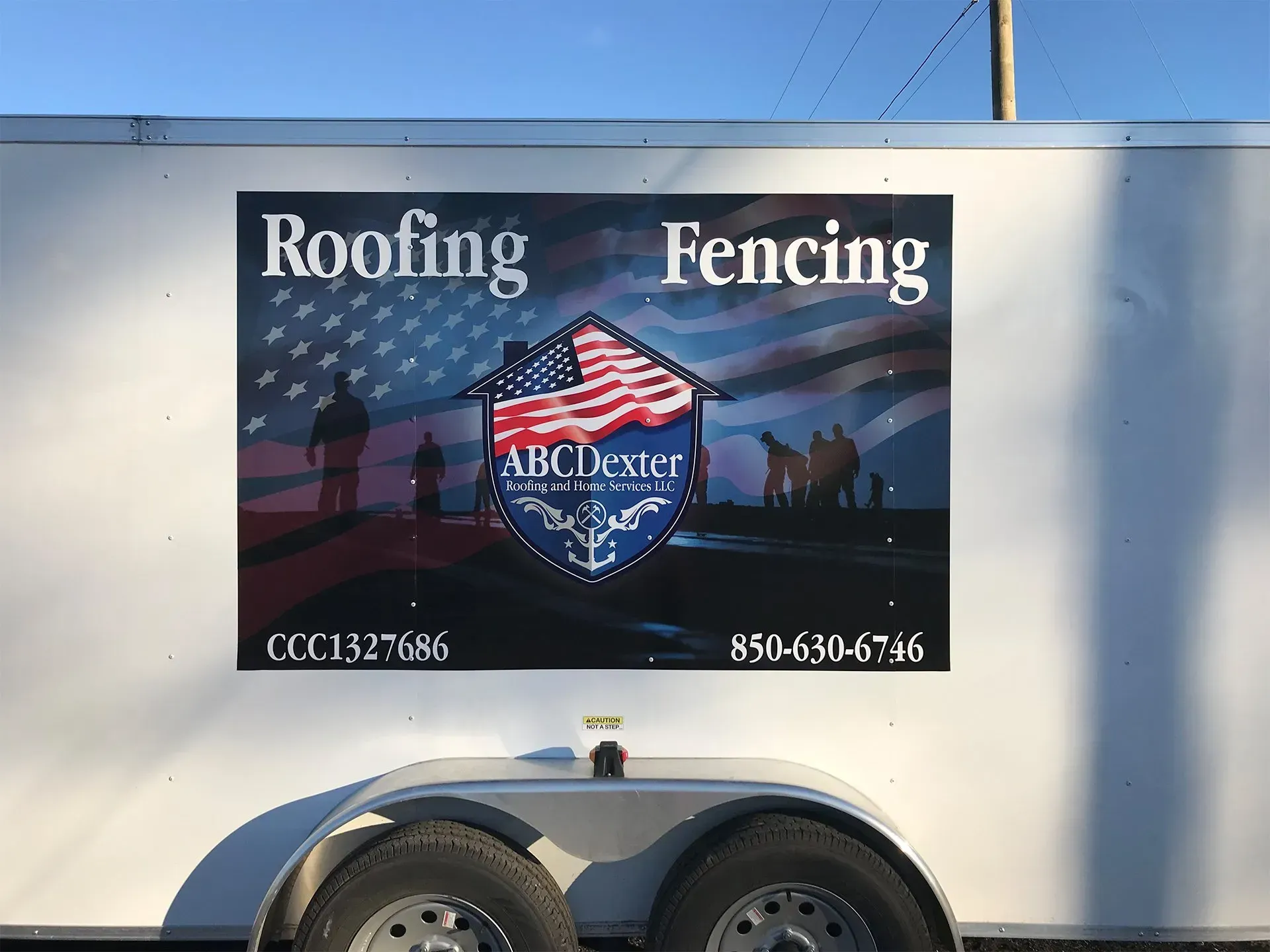 A trailer with a sign on it that says roofing and fencing