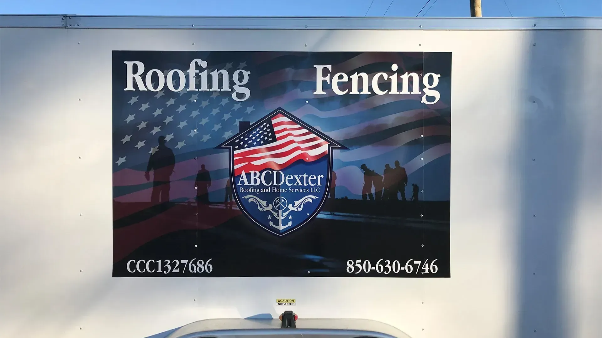 A trailer with a sign on it that says roofing and fencing