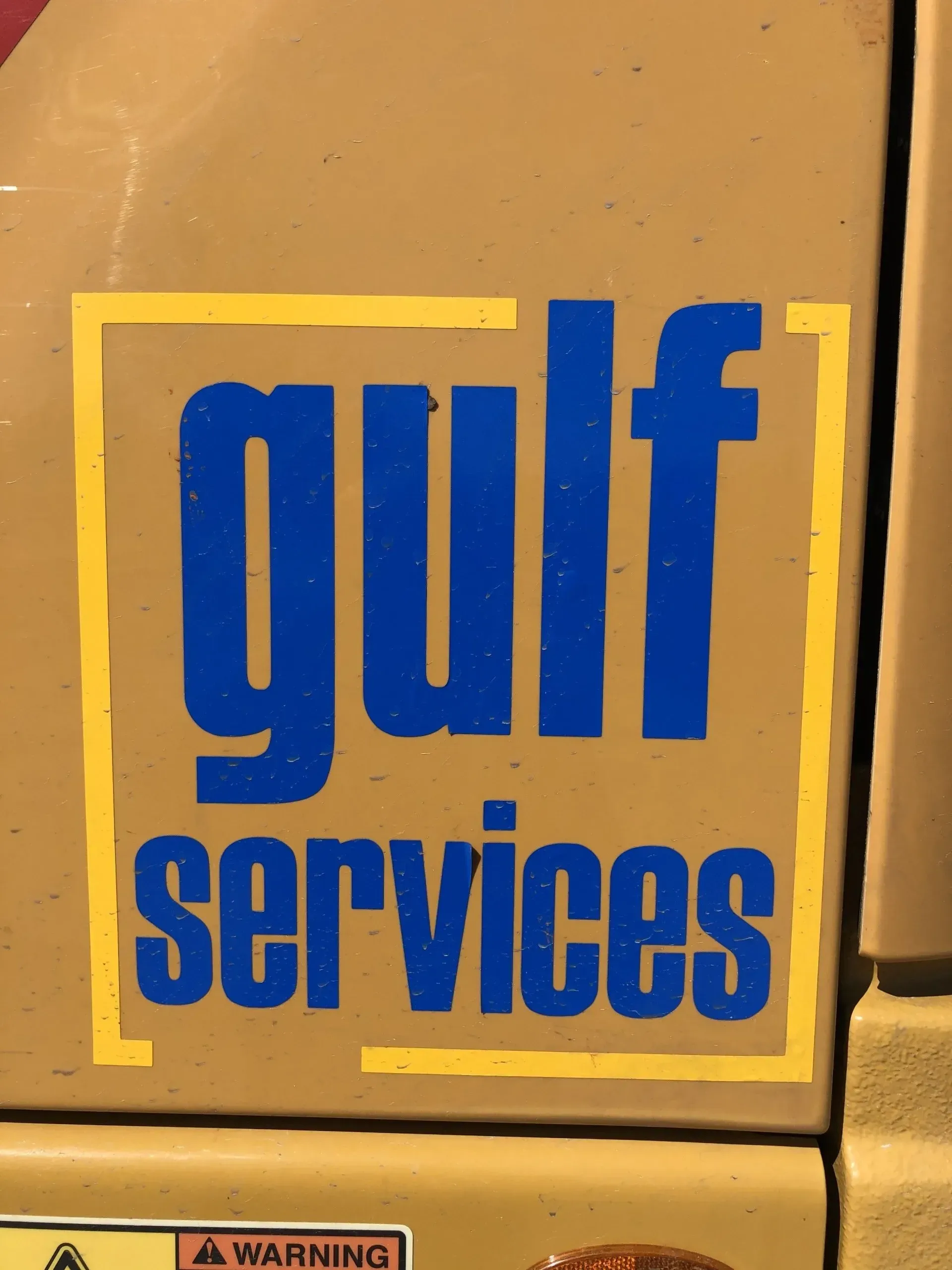 A gulf services logo is on the side of a vehicle