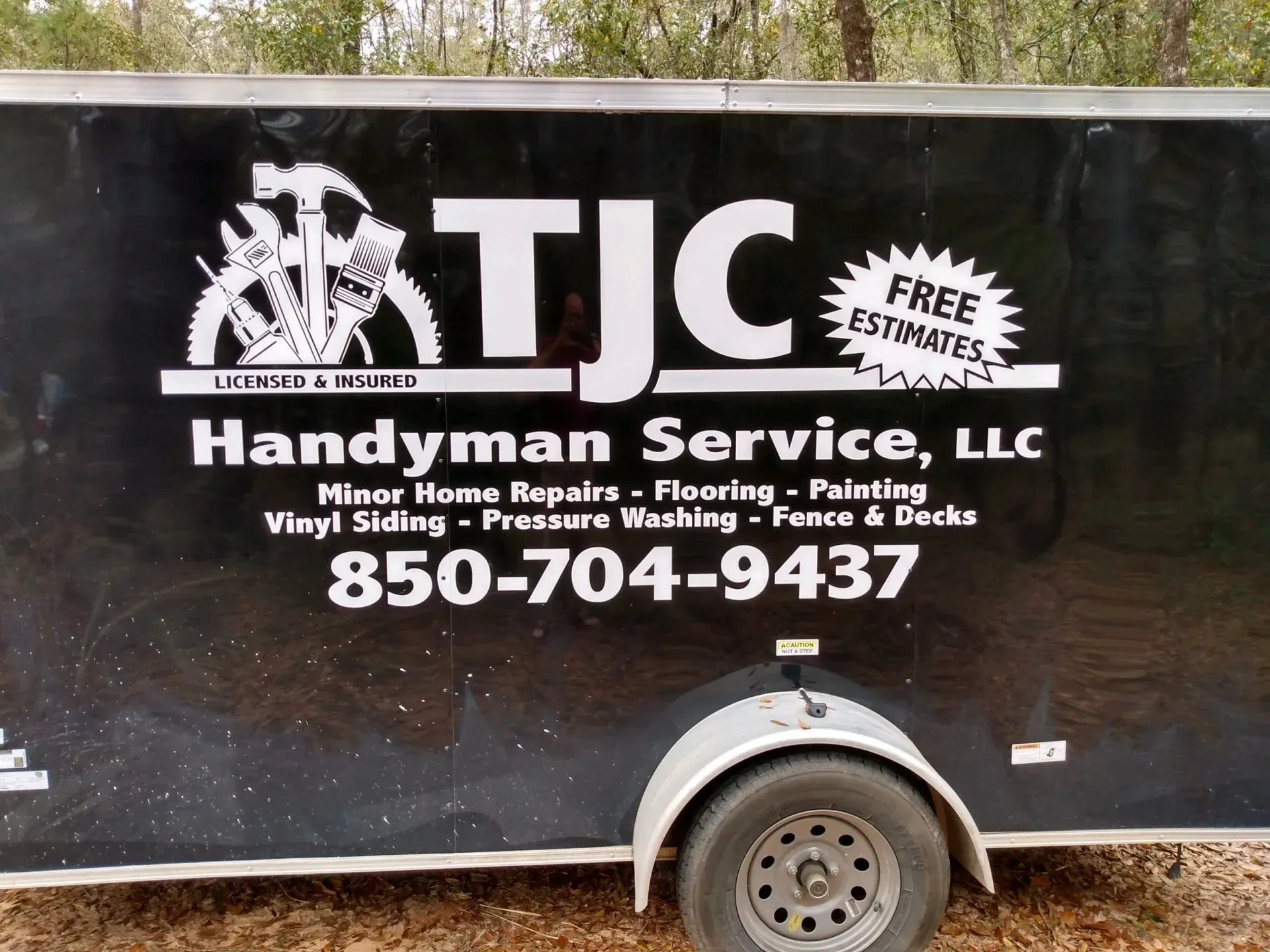A black trailer that says tjc handyman service llc