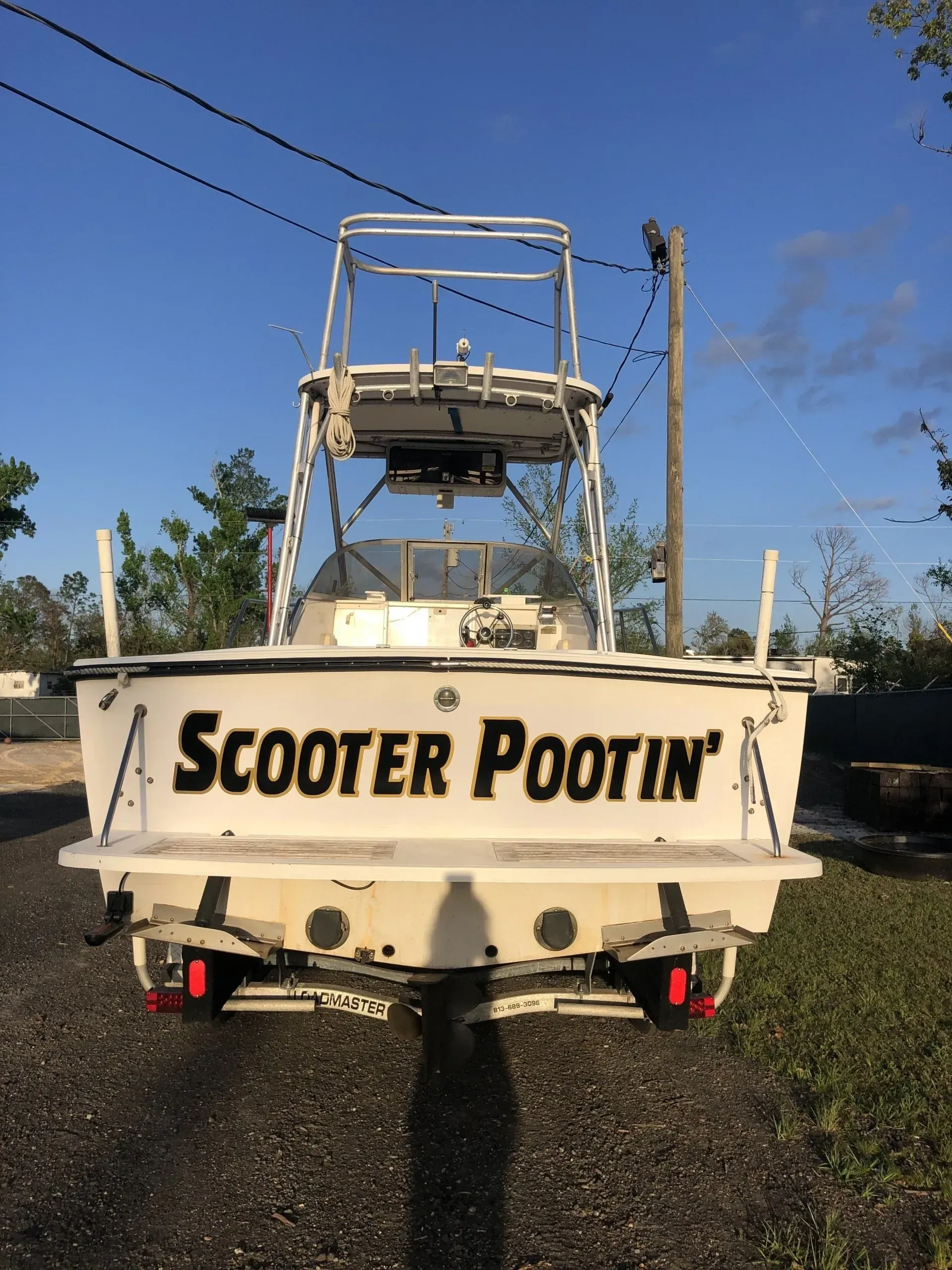 A white boat with scooter pootin written on the back