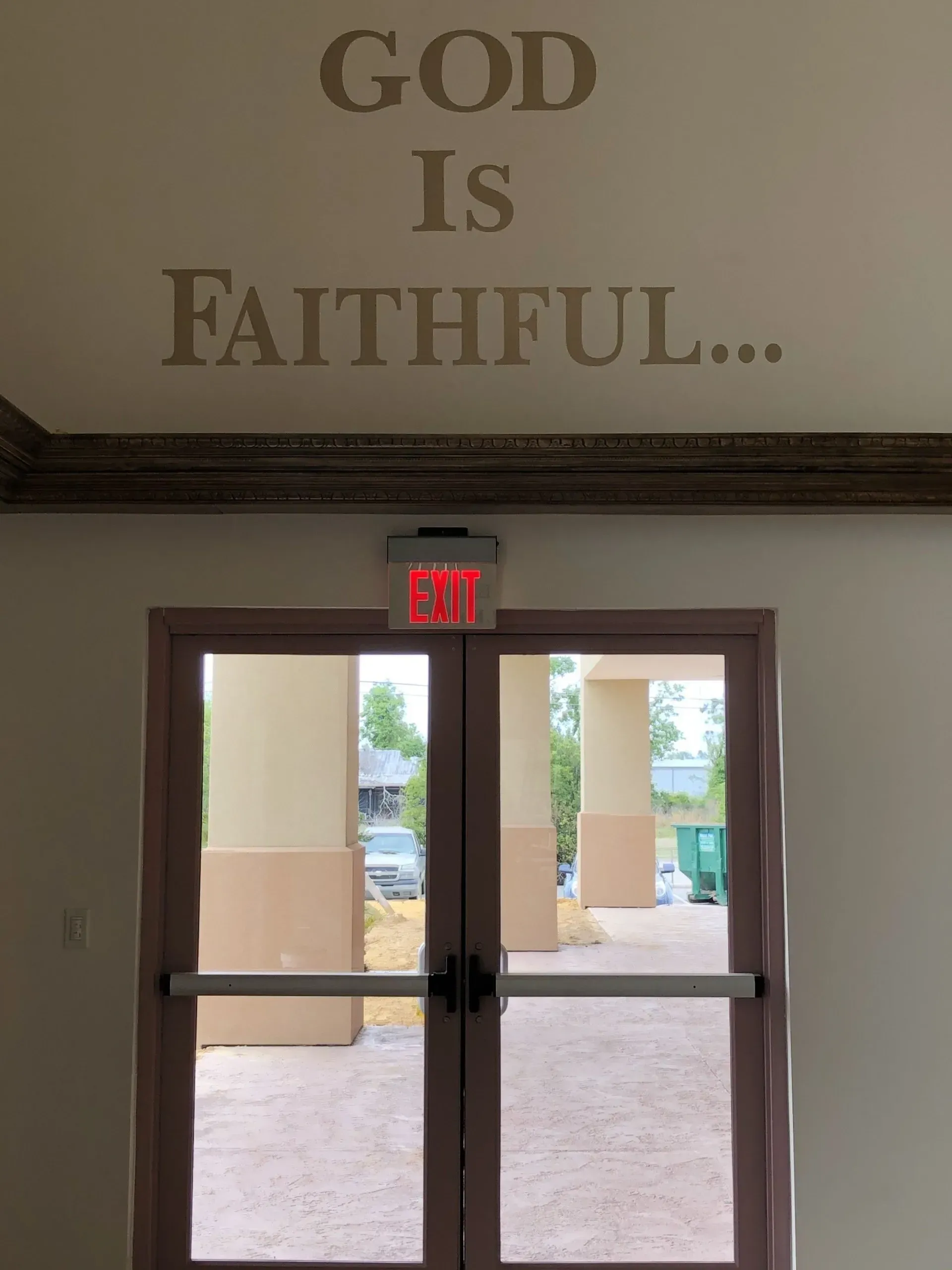 A door with the words god is faithful above it