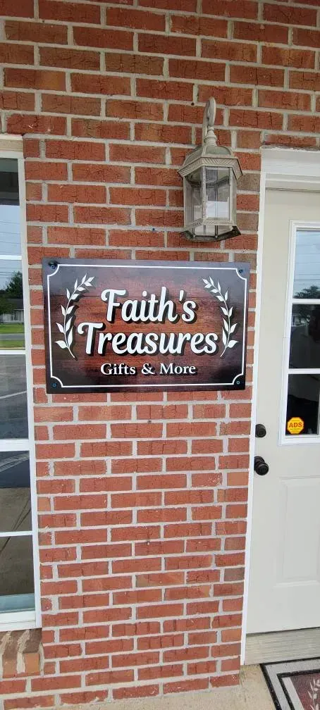 A brick building with a sign on it that says `` faith 's treasures ''.