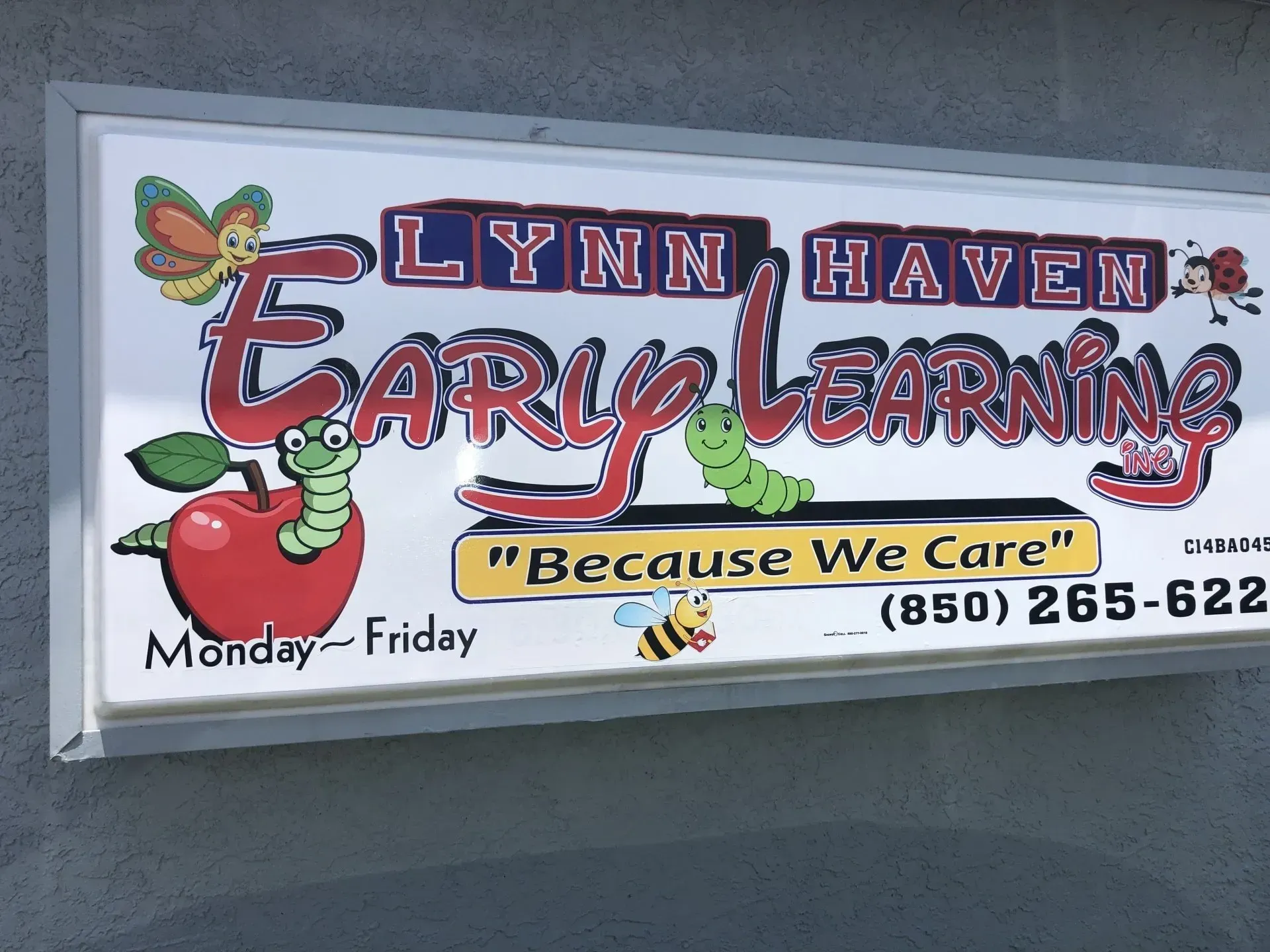 A sign for lynn haven early learning shows an apple and a worm