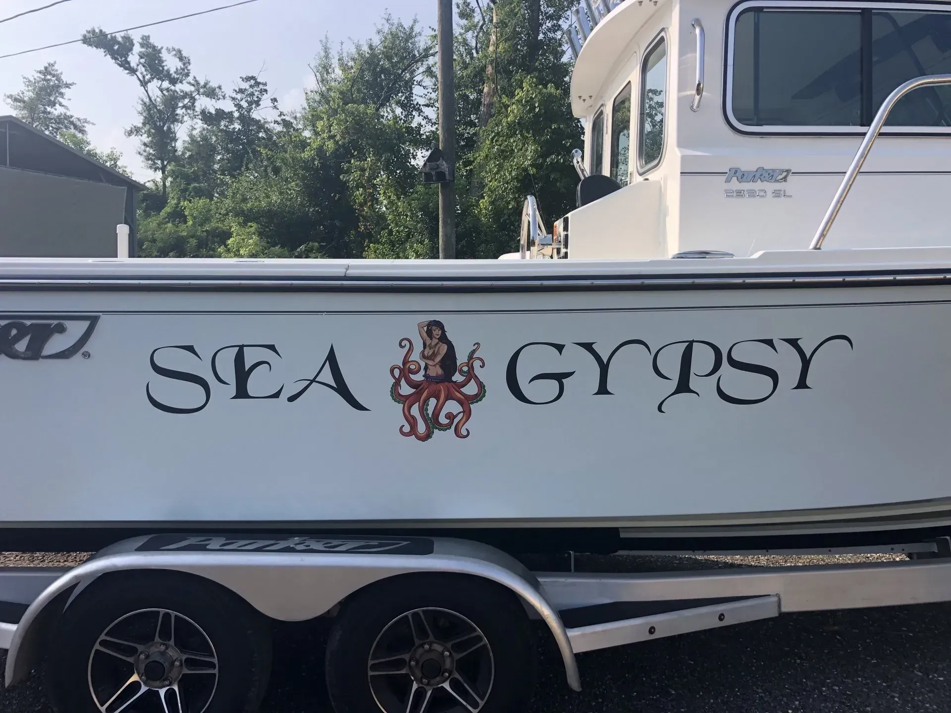 A white boat with the name sea gypsy on the side