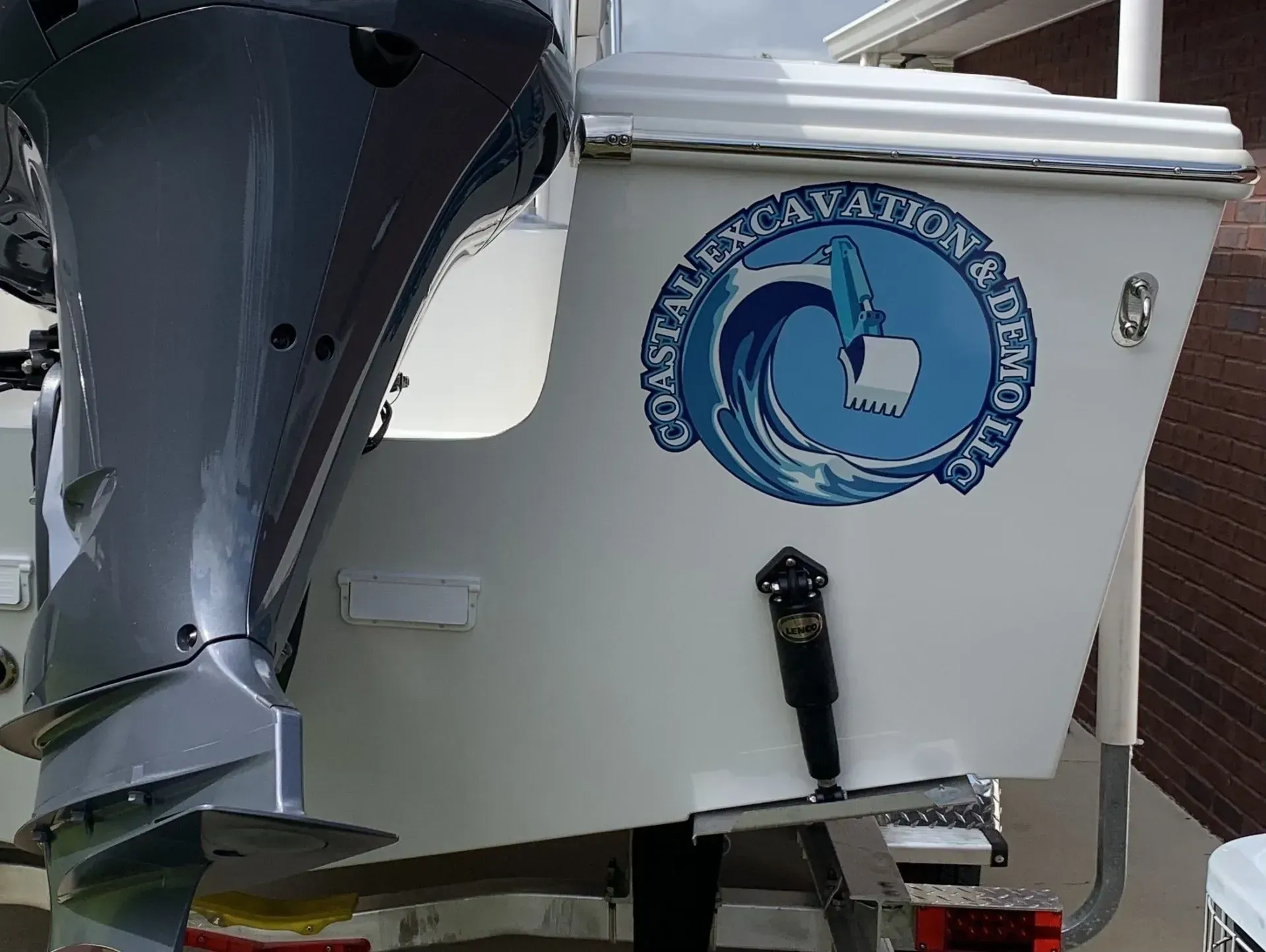 A boat with a logo that says coastal excavation and demolition