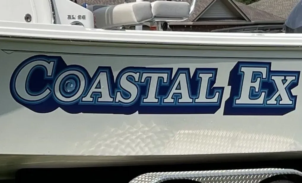 A boat that says coastal ex on the side