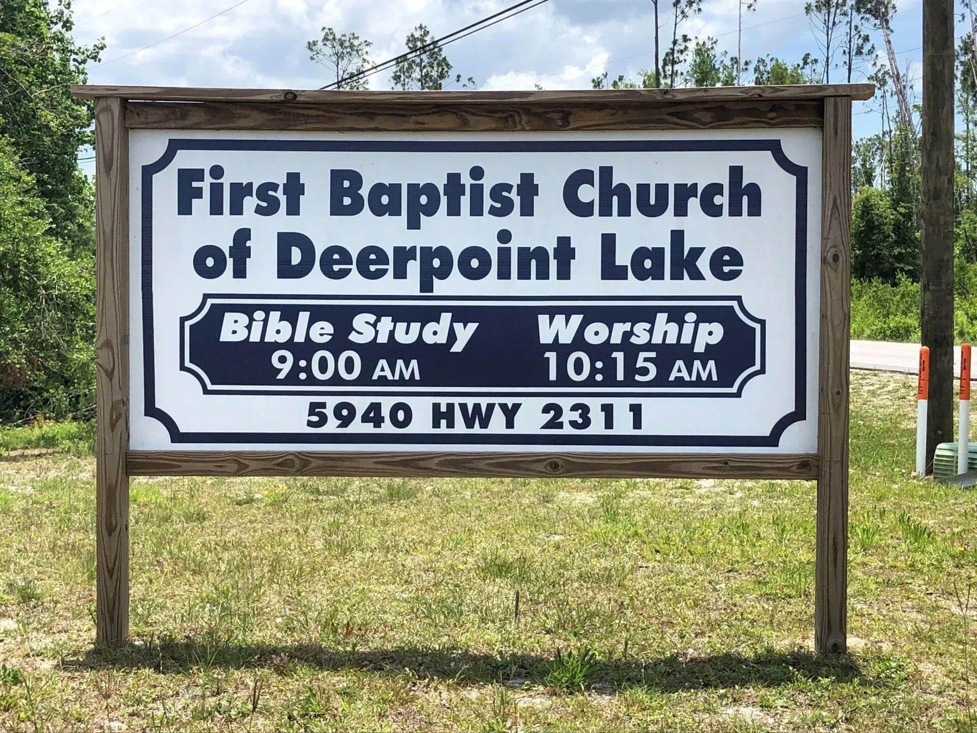 A sign for the first baptist church of deerpoint lake