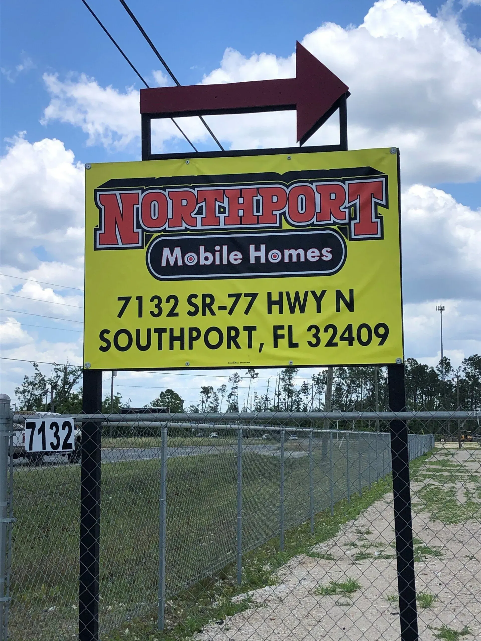 A yellow sign that says northport mobile homes on it