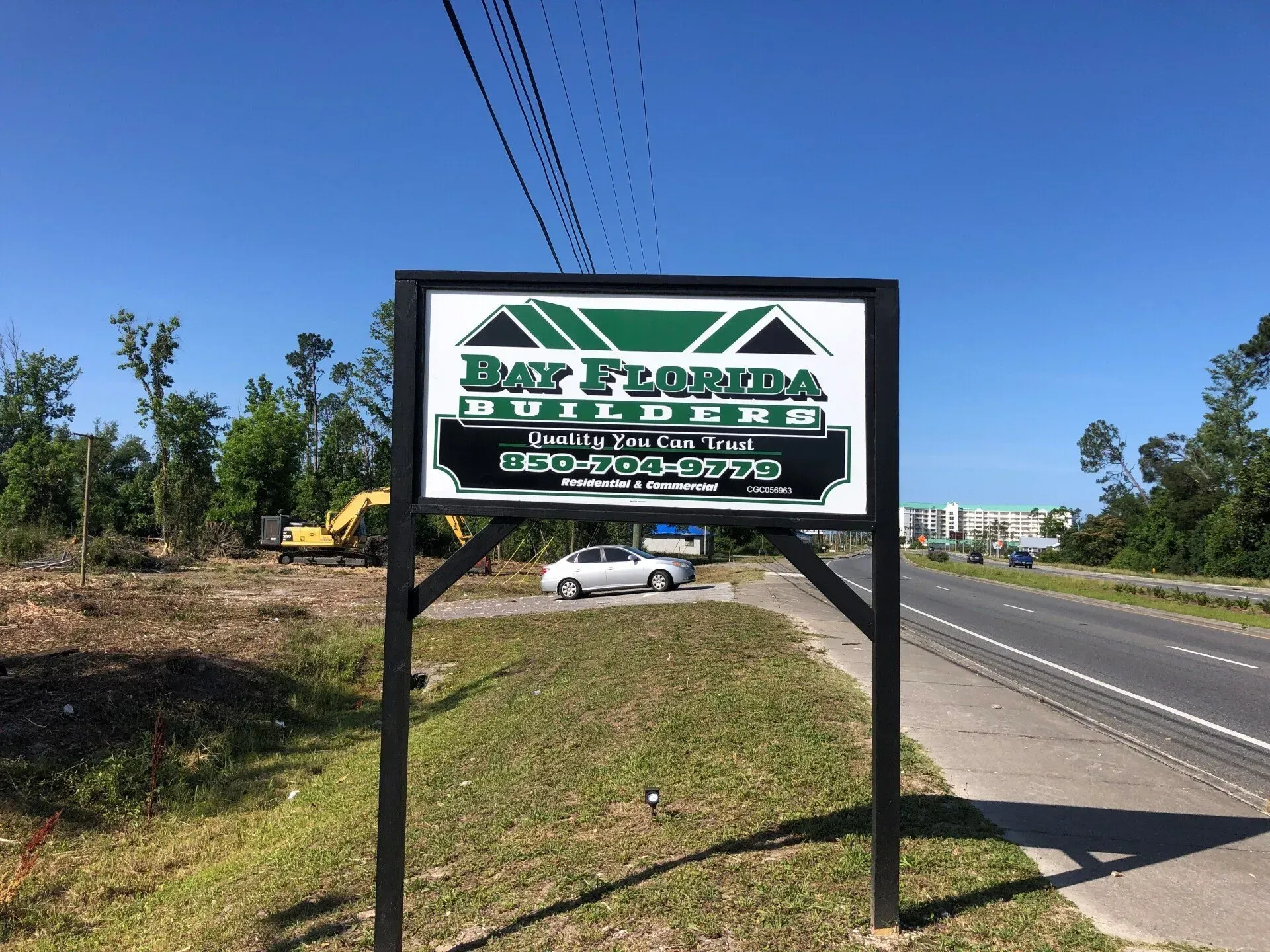 A sign for bay florida building is sitting on the side of a road.