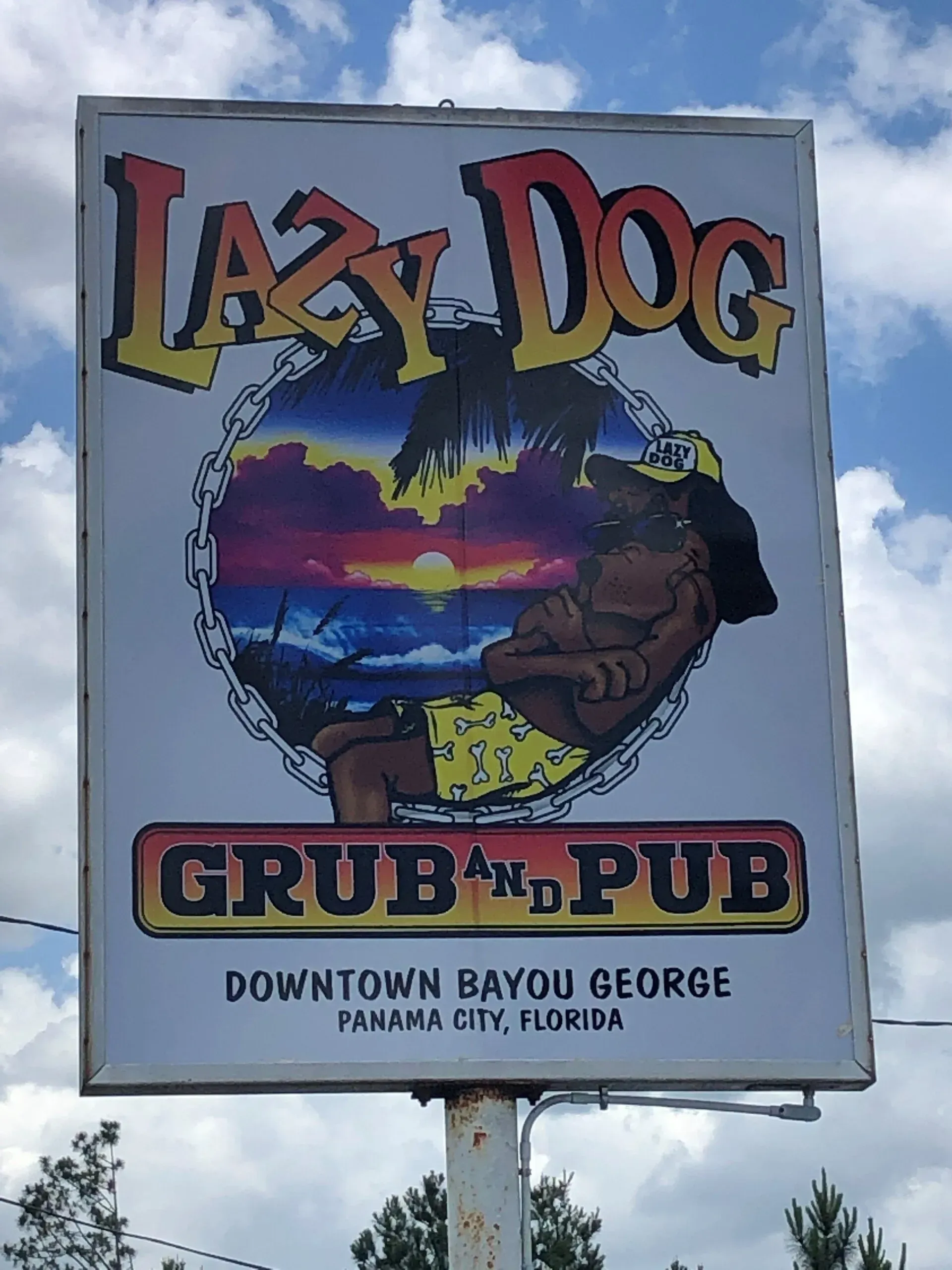 A sign for lazy dog grub and pub in downtown bayou george