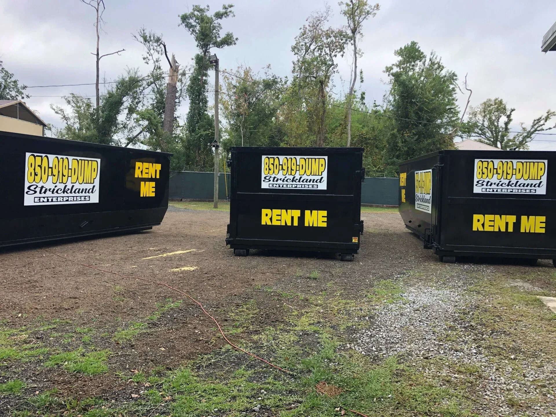 A row of dumpsters that say rent me on them
