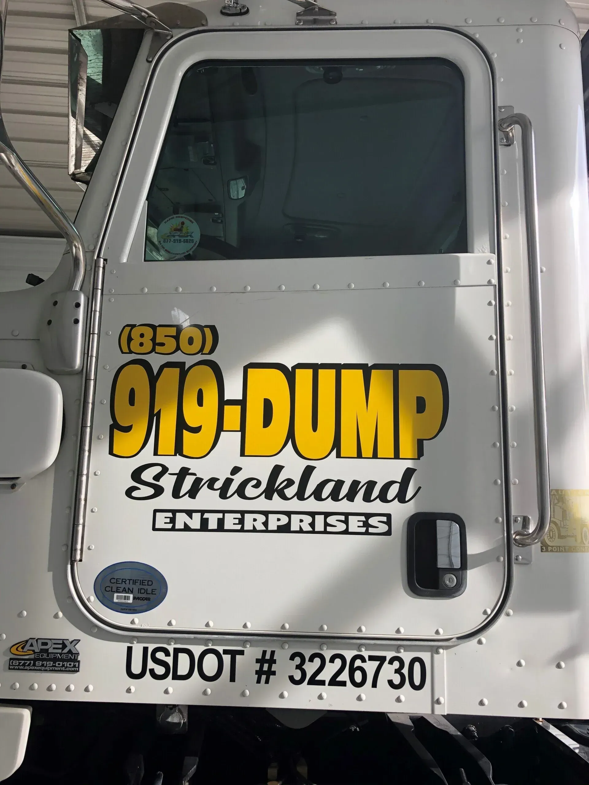 A white dump truck from 919 dump strickland enterprises
