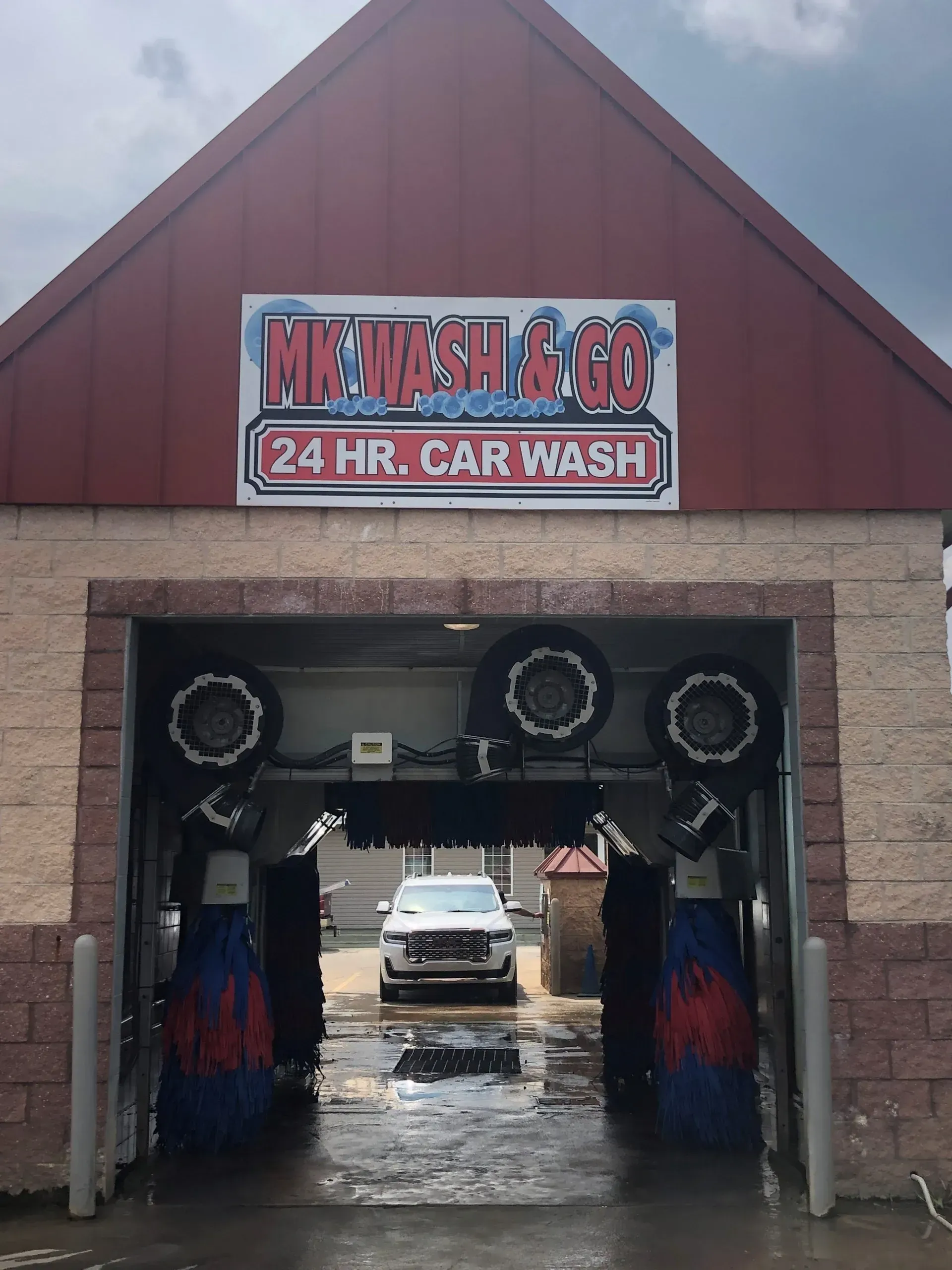 A car is going through a car wash at mk wash & go