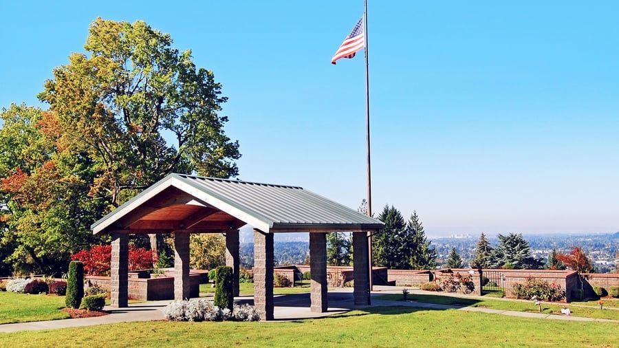 A pavilion with an american flag flying in the background