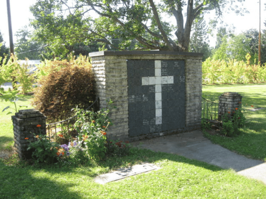 A brick wall with a cross painted on it