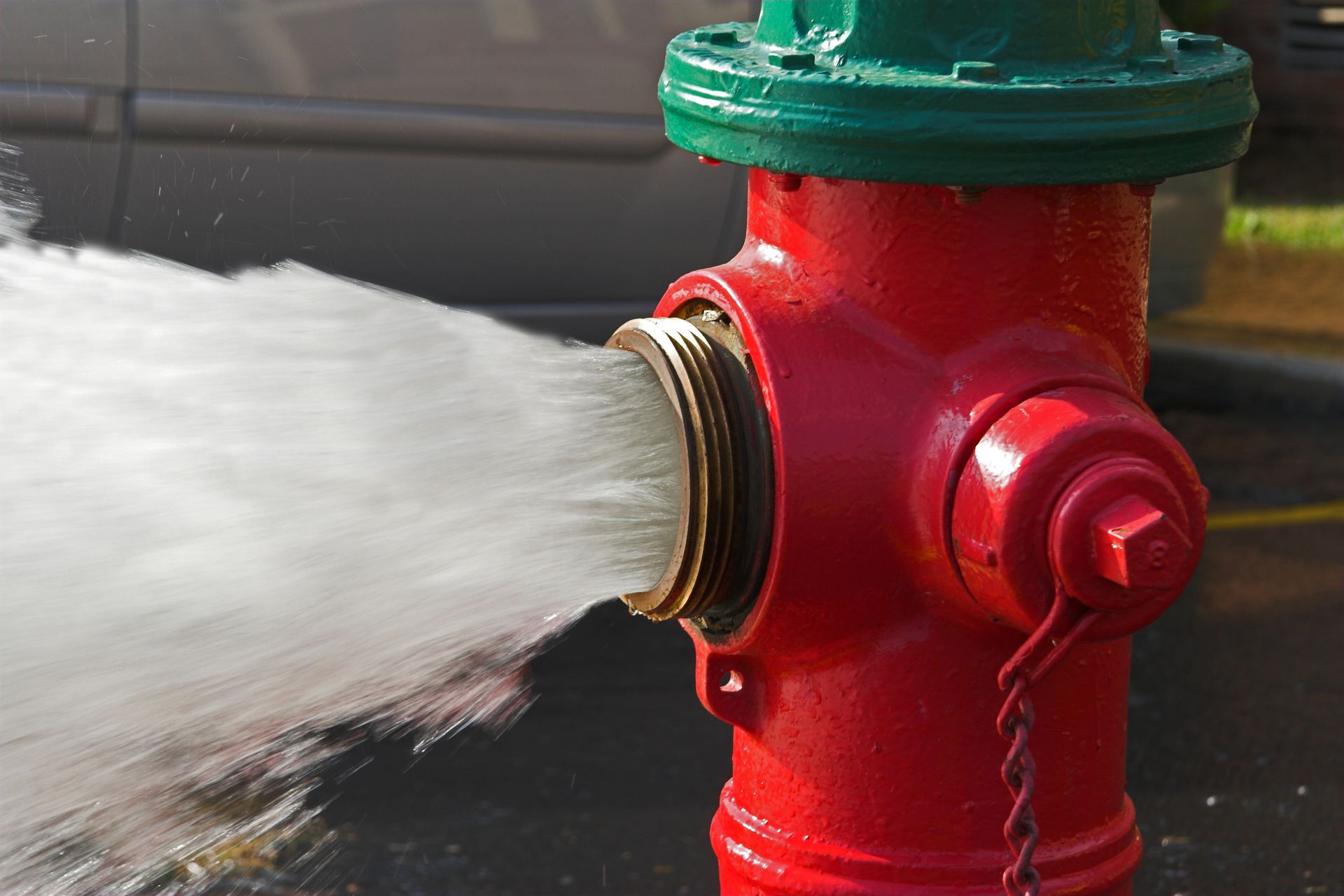 Water is expelled at a high velocity from a red fire hydrant. Water is expelled at a high velocity from a red fire hydrant.