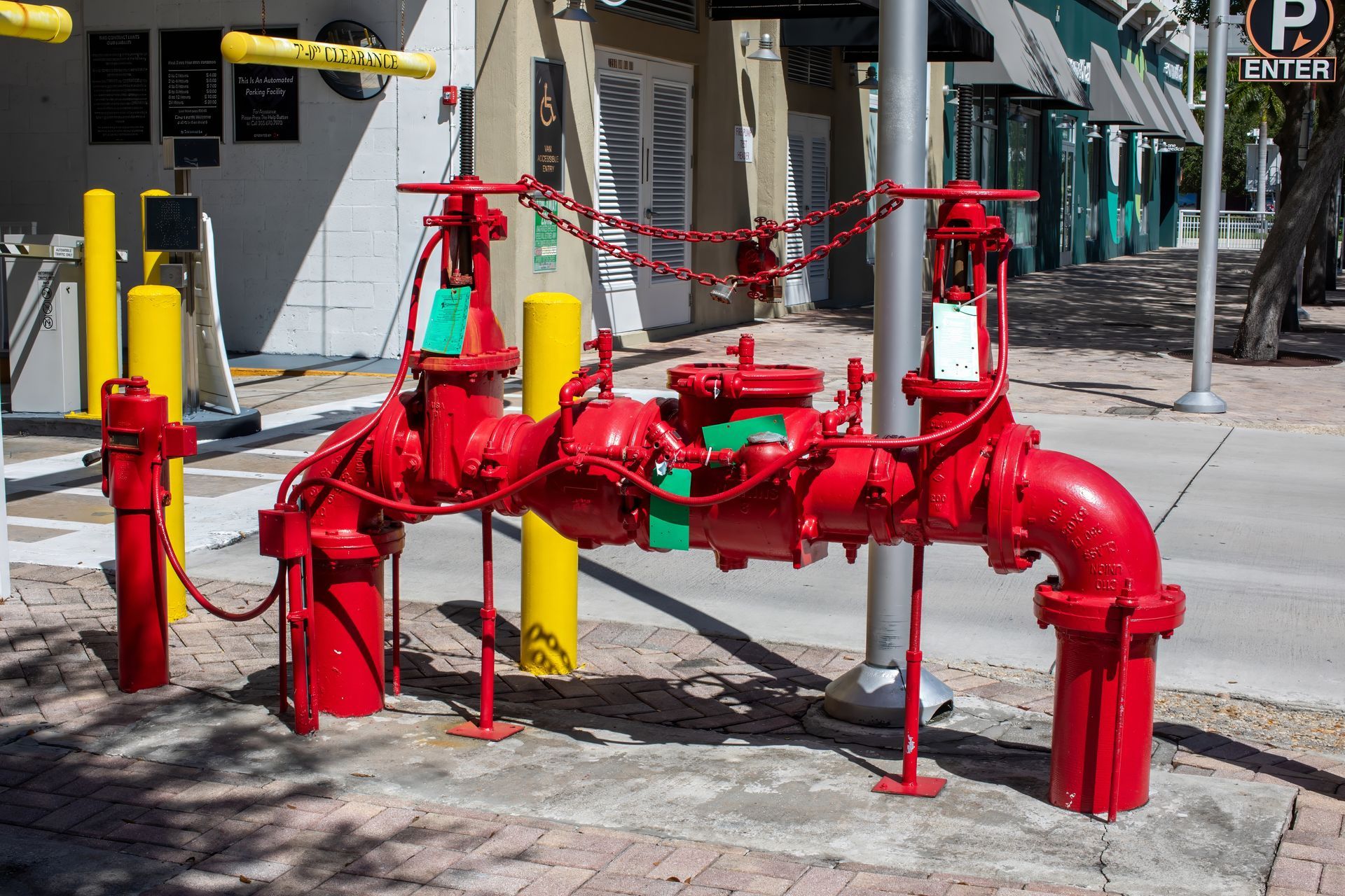 Red backflow device testing assembly installed on a sidewalk
