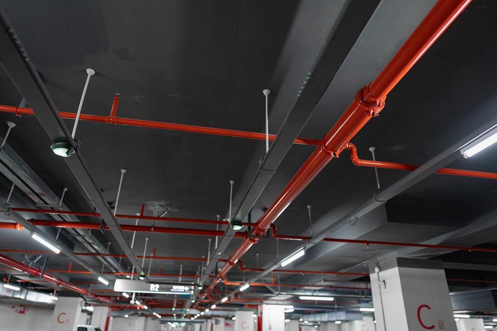 Ceiling-mounted red fire hose and sprinkler system for fire safety in buildings Ceiling-mounted red fire hose and sprinkler system for fire safety in buildings