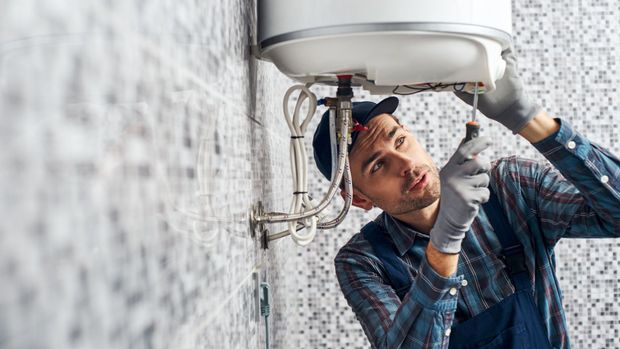 Plumber Fixing Water Heater