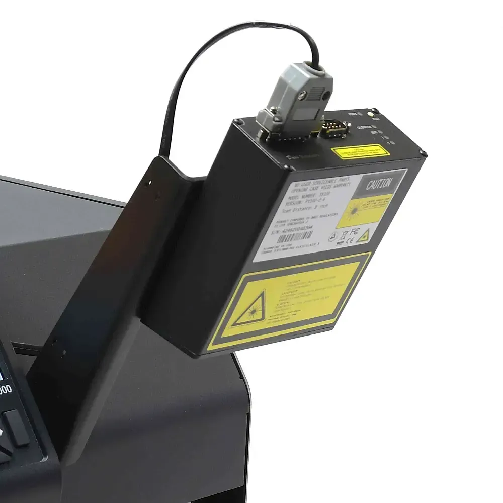 Black industrial device with warning labels mounted on a machine console