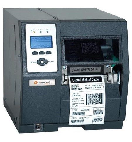 Gray desktop shipping label printer with a printed label coming out of the front slot
