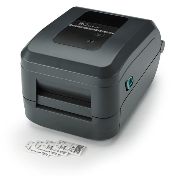 Compact gray label printer printing shipping labels onto a white surface