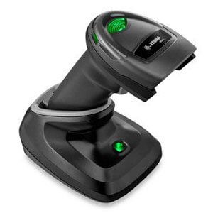 Black and green barcode scanner on a charging base