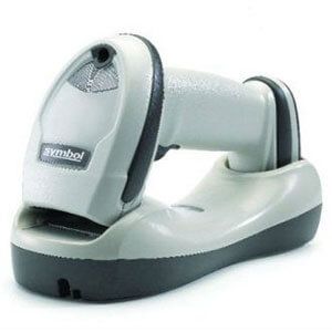 Gray handheld barcode scanner in charging cradle on white background