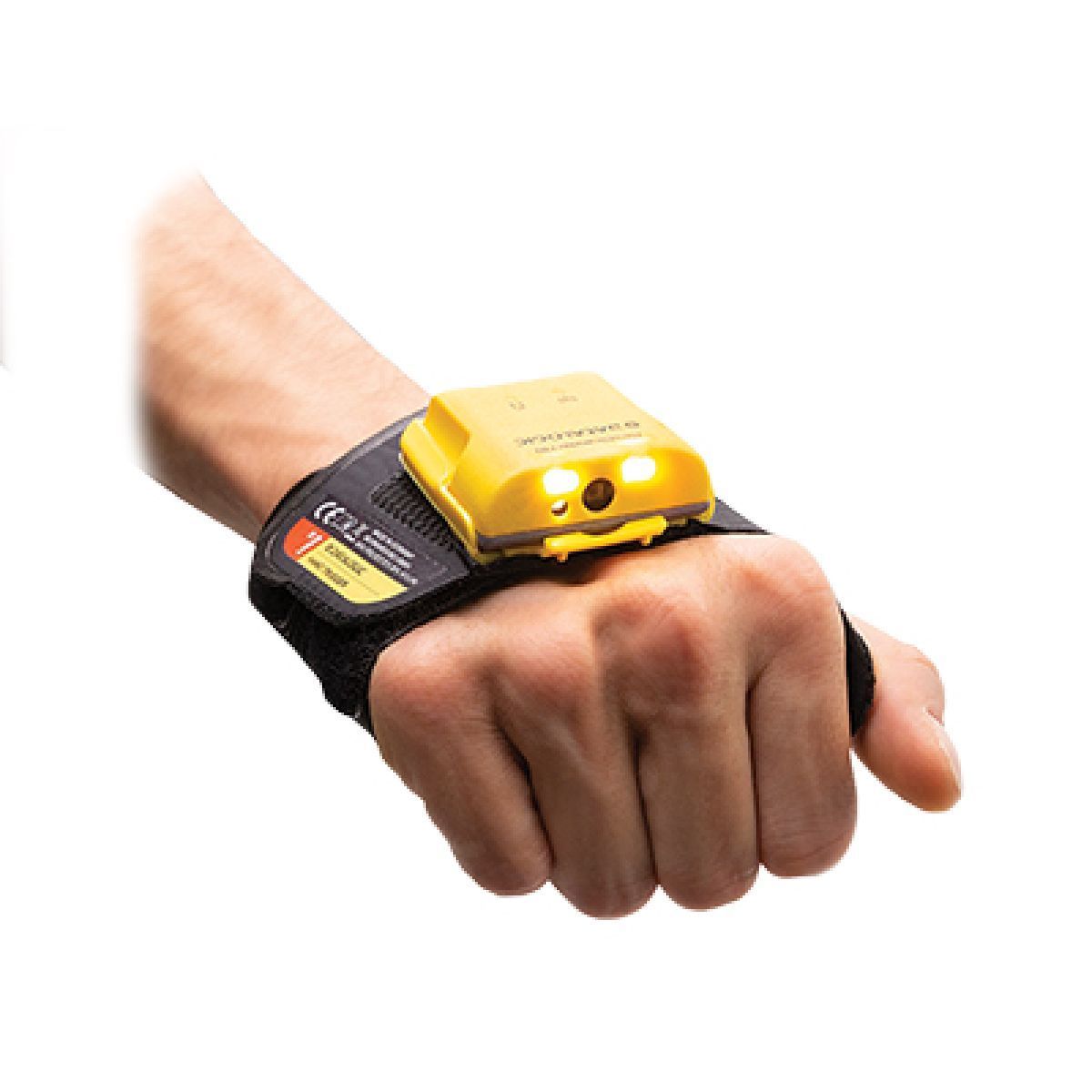 A yellow toy car mounted on a black wrist strap worn over a clenched hand