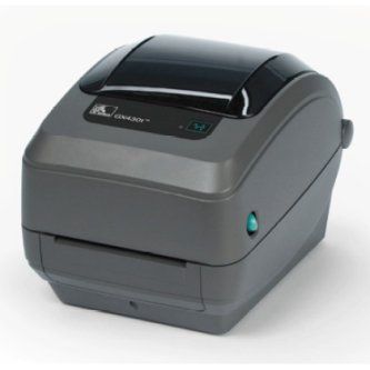 Compact gray desktop thermal label printer with a black top lid and teal status light
