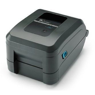 Gray desktop barcode label printer with a black top panel and teal side button, angled on a white background