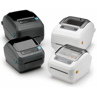 Four desktop label printers in black and white, shown in a stacked product display.