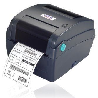 Black desktop label printer printing a shipping label on white paper