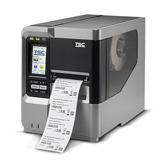 TSC industrial label printer printing a barcode shipping label on a roll of labels