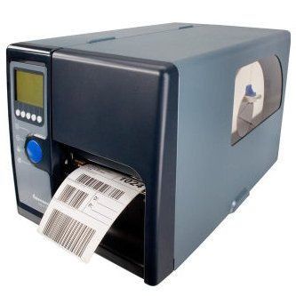 Desktop label printer printing a barcode label, with a small display and blue button on the front