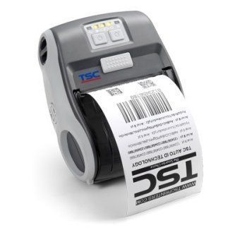 Gray TSC label printer printing a white barcode shipping label
