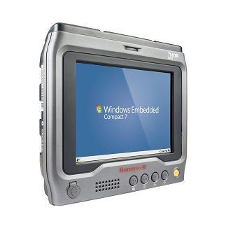 Rugged gray touchscreen industrial computer displaying Windows Embedded Compact 7 on a blue screen
