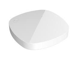 White round plastic device with a sloped top on a plain background