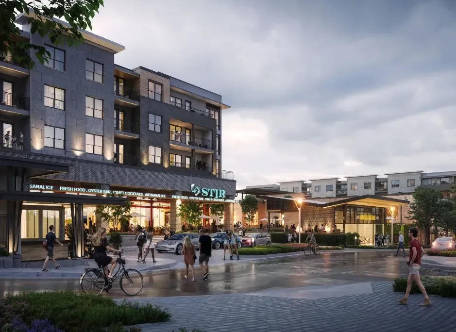 Exterior view of a mixed-use development with apartments above retail and dining.