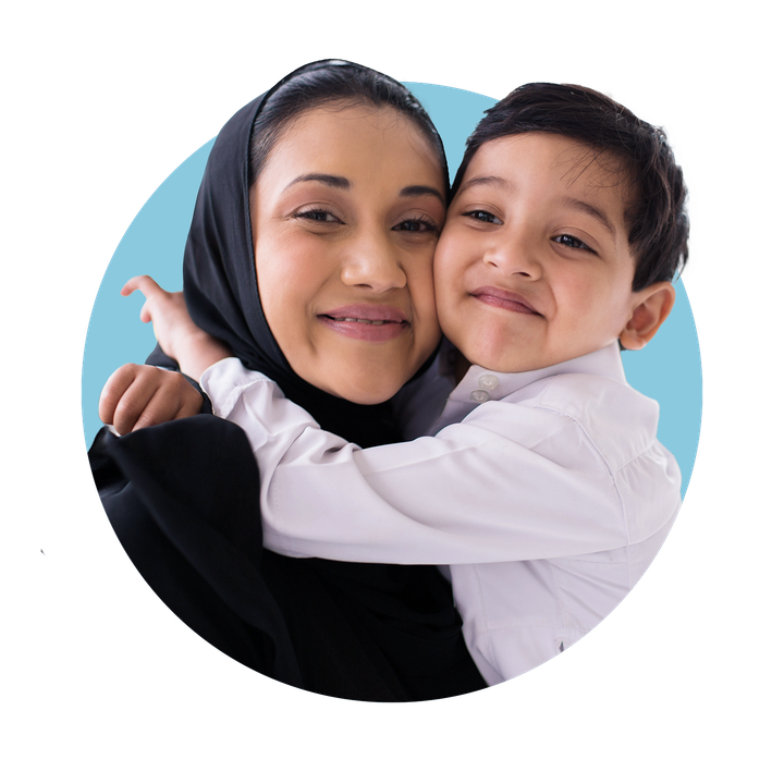 Young child embracing Mother, with both facing and smiling towards the camera