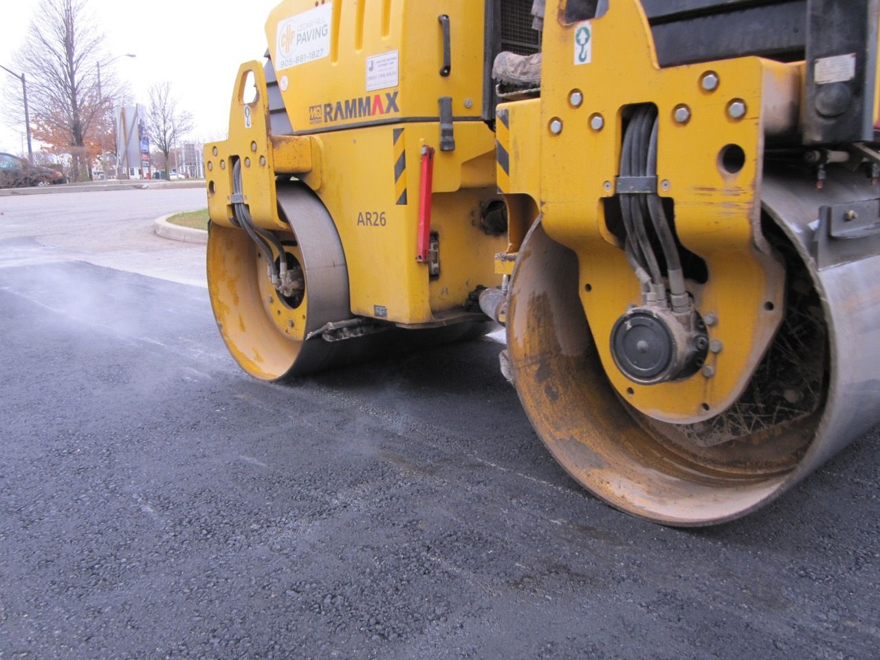 A yellow road roller with the letters bammax on the side