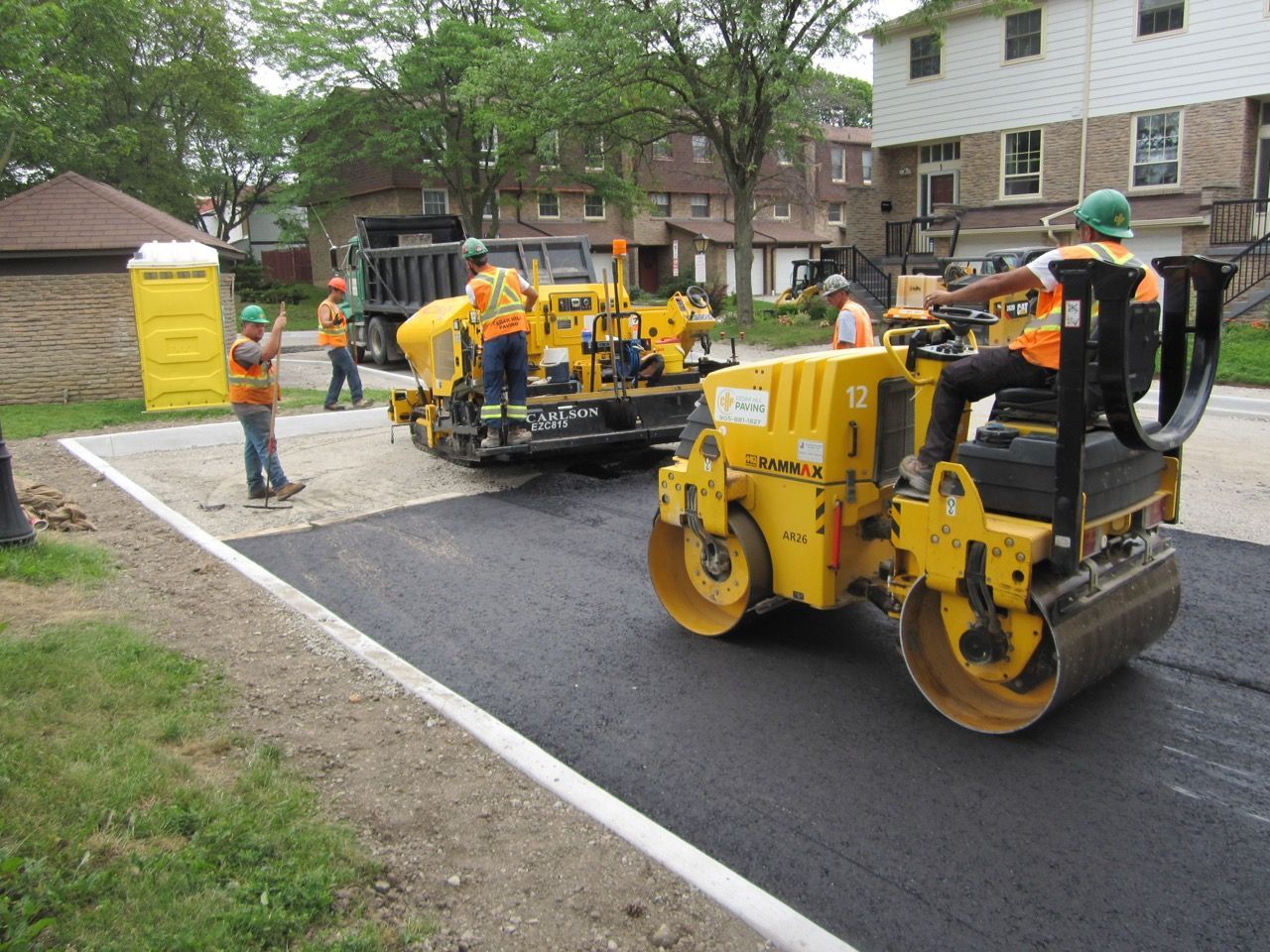 A group of construction workers are working on a road