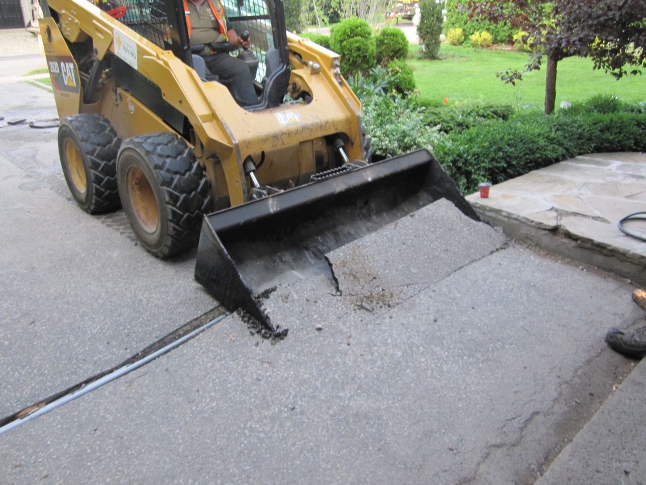 A man is driving a bulldozer on a street