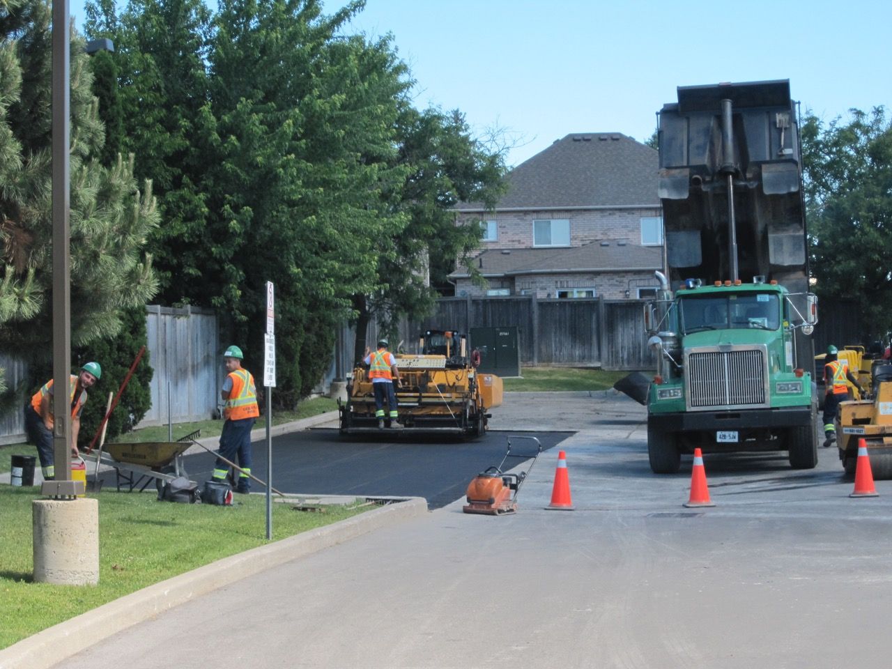 A group of construction workers are working on a road.