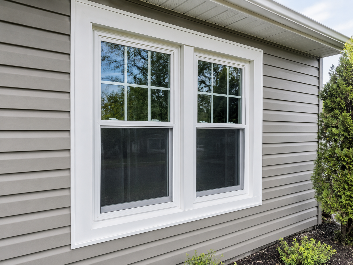 Blue house exterior with a white bay window and a small rectangular window beside it