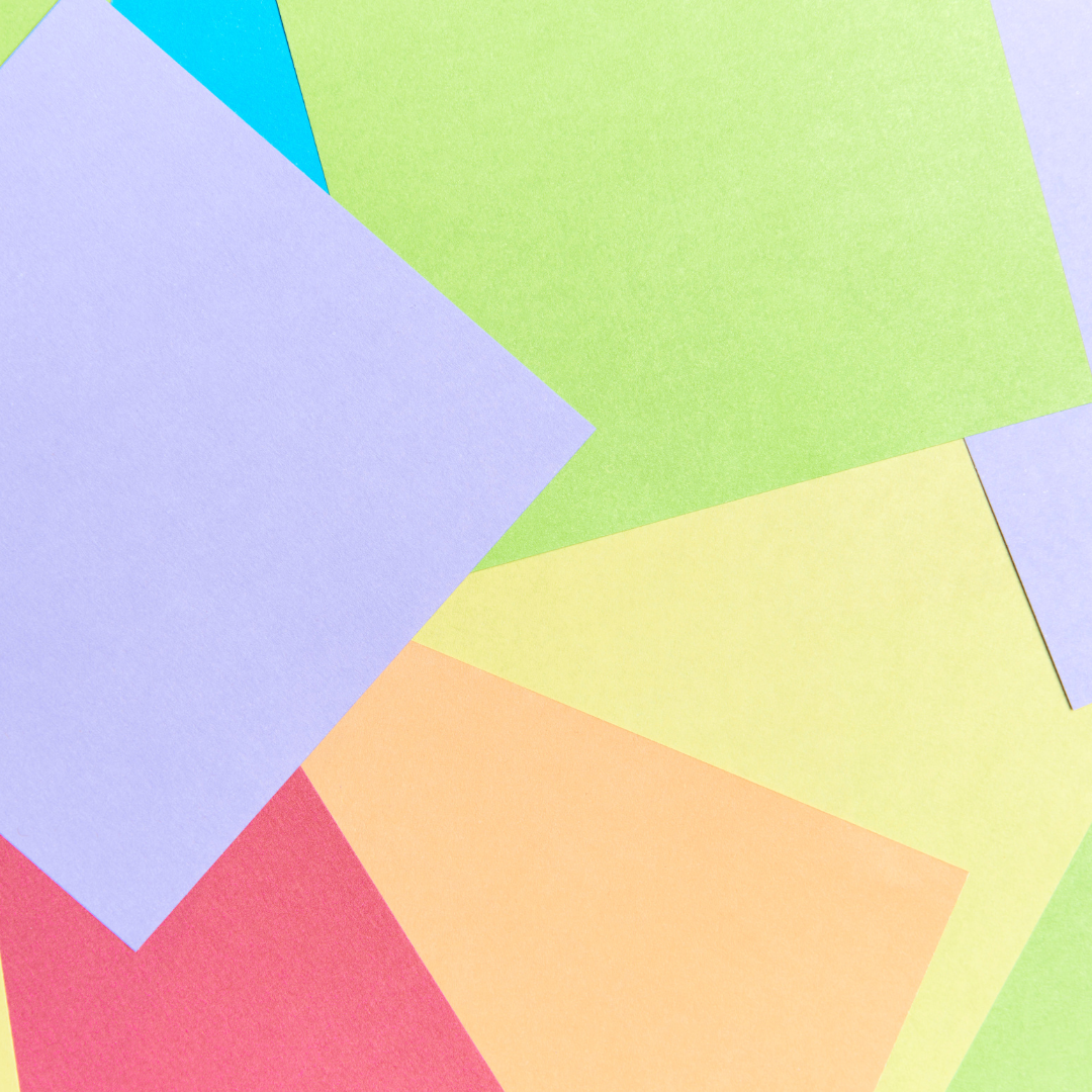 A close up of a bunch of different colored paper