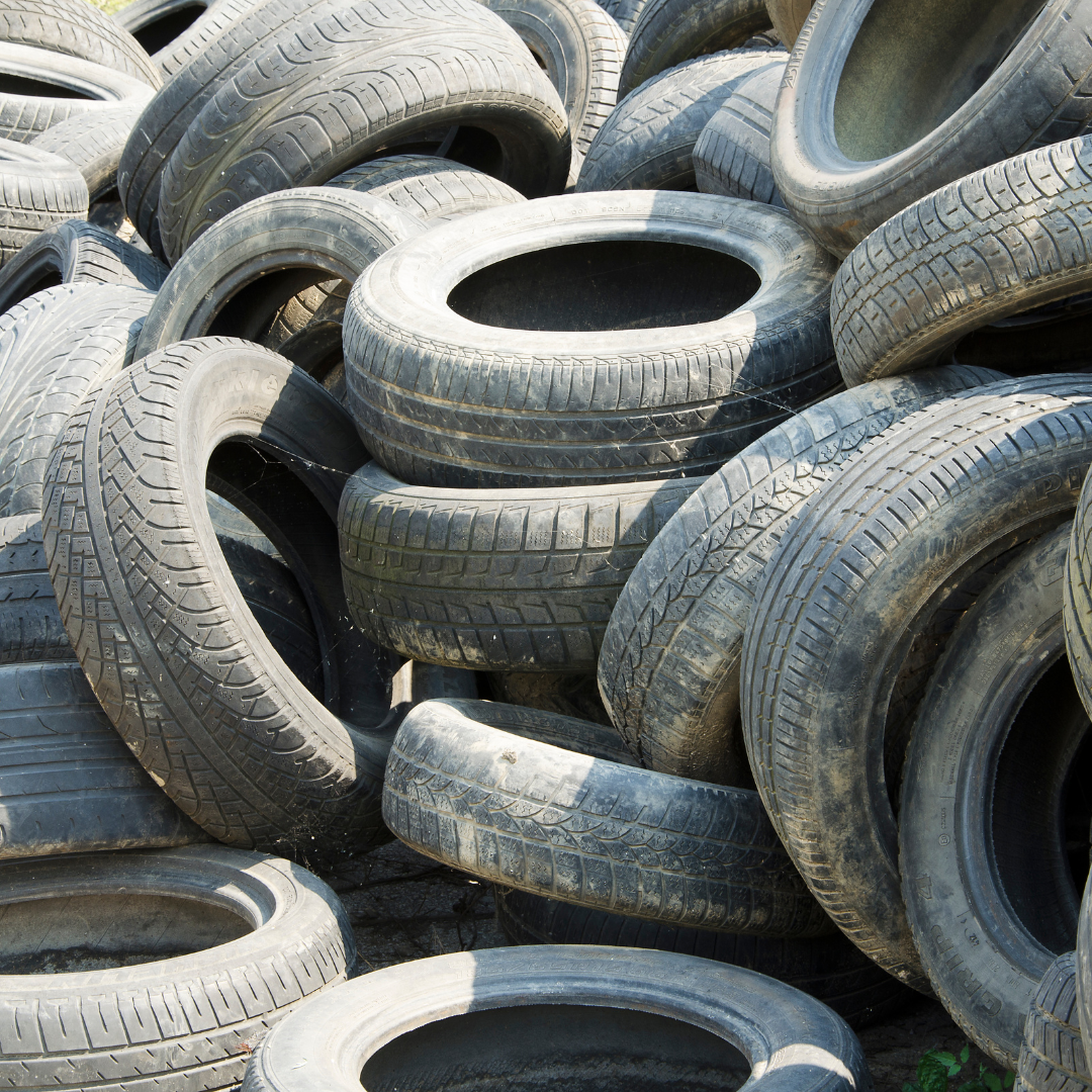 A pile of old tires are stacked on top of each other